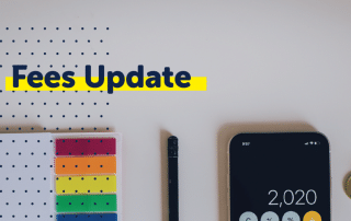 Fees Update" text on a banner above stationery items and a smartphone displaying the number 2020, featuring the WUSA logo in the corner.