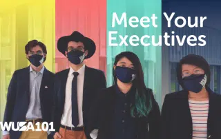 Four individuals wearing face masks and business attire stand side by side against a colorful, vertically striped background with the text "Meet Your Executives" and the logo "WUSA 101" displayed.