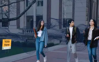 Three young people walk on a campus sidewalk, passing by a "Vote Here" sign with an arrow. They carry books and appear to be engaged in conversation about the Ontario Provincial Election taking place in June 2022.