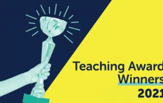 A hand holding a trophy is presented on a split background of dark blue and yellow. The text on the right reads, "2021 Winners: Teaching Award" in blue and yellow font, celebrating the WUSA Excellence in Undergraduate Teaching Award.