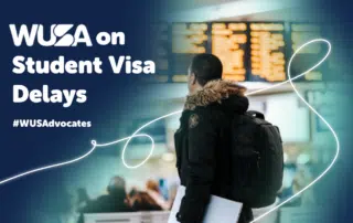 A person in a jacket with a backpack looks at an information board in a busy terminal. The text reads "WUSA on Student Visa Delays #WUSAdvocates". White lines add decorative elements across the image.