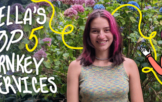 A person with pink-highlighted hair smiles at the camera, standing in front of vibrant hydrangea bushes. The text "BELLA'S TURNKEY SERVICES" appears in bold white letters on the left. On the right, an illustrated character with similar features waves excitedly, celebrating Bella's Top 5 Turnkey Services.