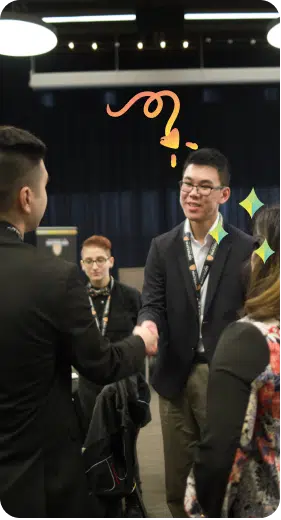 A man in a black suit shakes hands with another man in a dark blazer during a networking event. Other attendees are seated at tables in the background. Vibrant doodles with hearts and sparkles add a playful touch to the image.