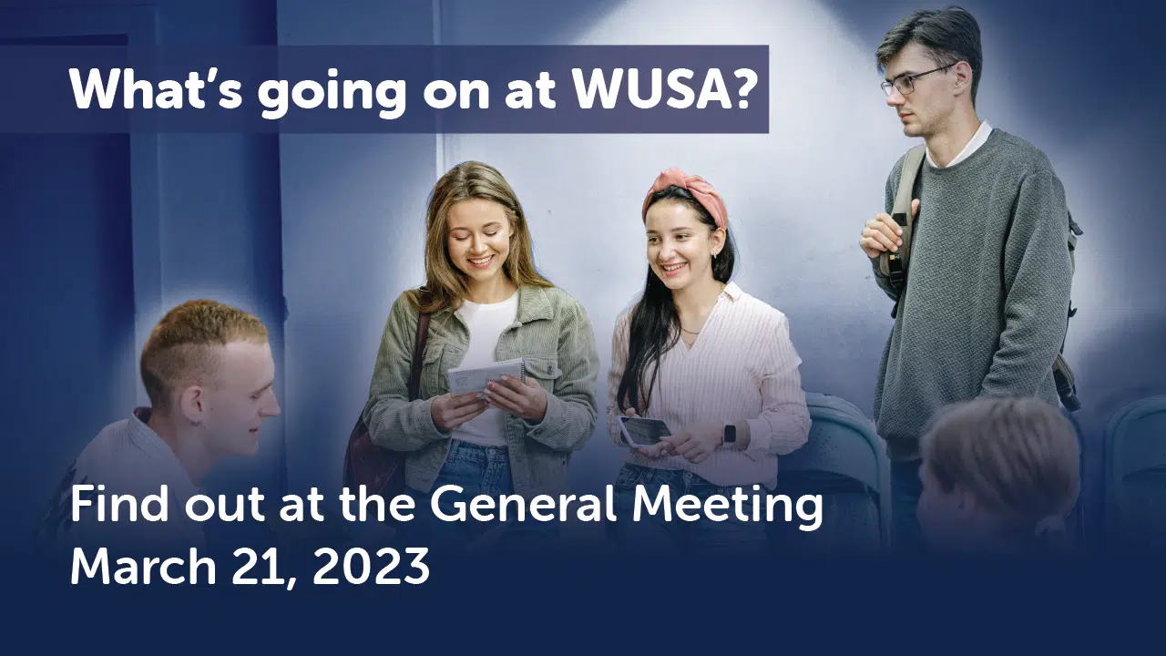 A group of people talking and exchanging papers, with a banner above them reading, "What's going on at WUSA?" Text below the image announces, "Find out at the 2023 Meeting on March 21."
