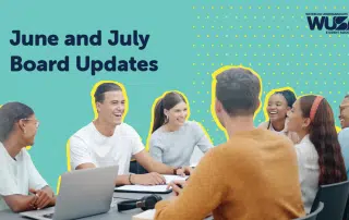 A group of diverse individuals sits around a table, engaged in discussion and smiling. Laptops and notebooks are visible on the table. The text reads, "Re-cap: June and July Board Meetings" and "Waterloo Undergraduate Student Association (WUSA)" with the WUSA logo.