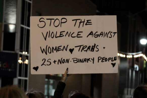 Image of a sign reading 'Stop the violence against women, trans, 2S, and non-binary people.