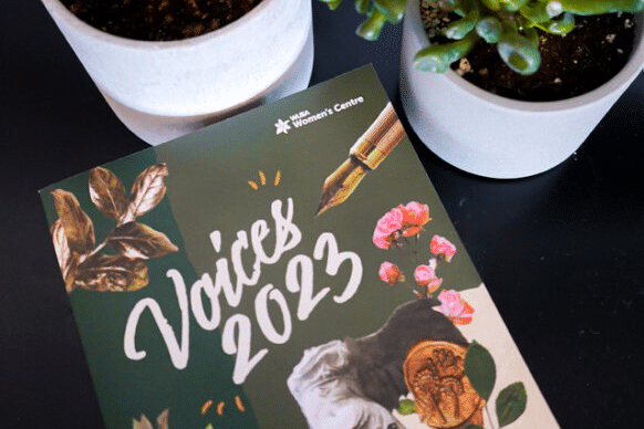 A physical copy of Voice 2023 positioned among some house plants