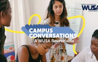 A group of four students, three sitting and one standing, engaged in discussion around a table. The image includes a yellow swirling line and the text "Campus Conversations: A WUSA Roundtable". The WUSA logo is in the top right corner.