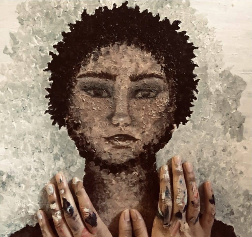 A textured painting depicts a person with curly hair looking forward, surrounded by a light-colored, almost cloud-like background. The person's hands, covered in paint, are held up near their chest, displaying an artistic and contemplative expression—an evocative preview of the 2024 Consent Calendar.