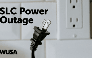 Image of an unplugged electrical cord in front of a white power outlet, with the text "SLC Power Outage" in bold black letters on the left and "WUSA" in smaller black letters at the bottom left. The background features a tiled wall. Note: This occurred on Sunday, February 25th.