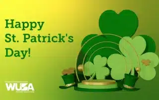 A festive St. Patrick's Day image featuring green shamrocks, leprechaun hats, and gold arch motifs on a gradient green background. Bold green text reads "Happy St. Patrick's Day!" The WUSA logo and name, Waterloo Undergraduate Student Association, are at the bottom. Remember to celebrate with consent!