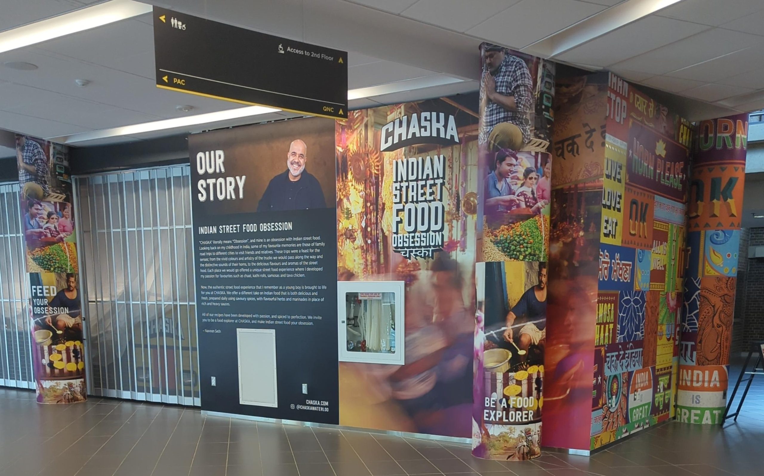 The image shows a vibrant restaurant storefront in an airport with colorful wall art depicting Indian street food and cultural scenes. A prominent sign reads "Chaska: Indian Street Food Obsession." A large poster outlines the restaurant's story and mission, almost like a board meeting recap from June.