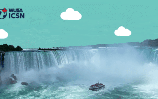 Scenic view of the famous Niagara Falls, a renowned tourist attraction, with a tour boat below. Text on image: "WUSA ICSN" with a globe and maple leaf icon.