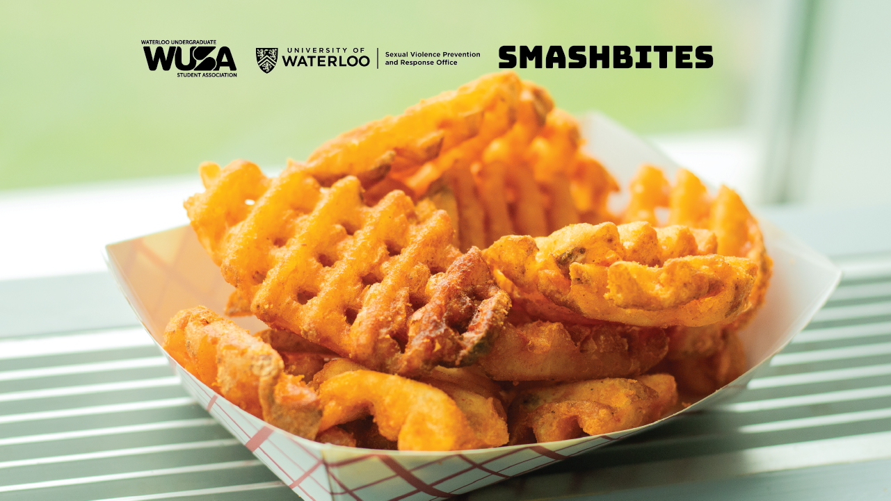 A basket of crispy waffle fries sits on the counter, perfectly seasoned. In the background, logos for WUSA, University of Waterloo, and Smashbites subtly remind you of where to get these delightful F.R.I.E.S.