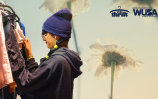 A person in a beanie browses clothes on a rack, surrounded by WUSA Thrift logos set against a vibrant, spring-inspired floral background.
