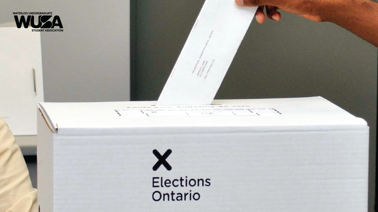 A person casts their vote into an Elections Ontario box, preparing for the upcoming provincial election.