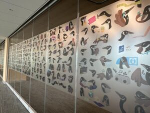 geese pattern along the glass wall of the black and gold room.