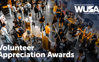Students gather around display tables at the WUSA Volunteer Awards, celebrating Student Excellence during Winter 2025.