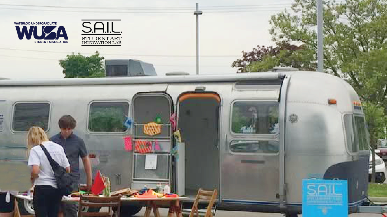A silver trailer with an open door serves as a Pop-Up Art Lab, featuring art supplies and people nearby; SAIL and WUSA logos are visible.