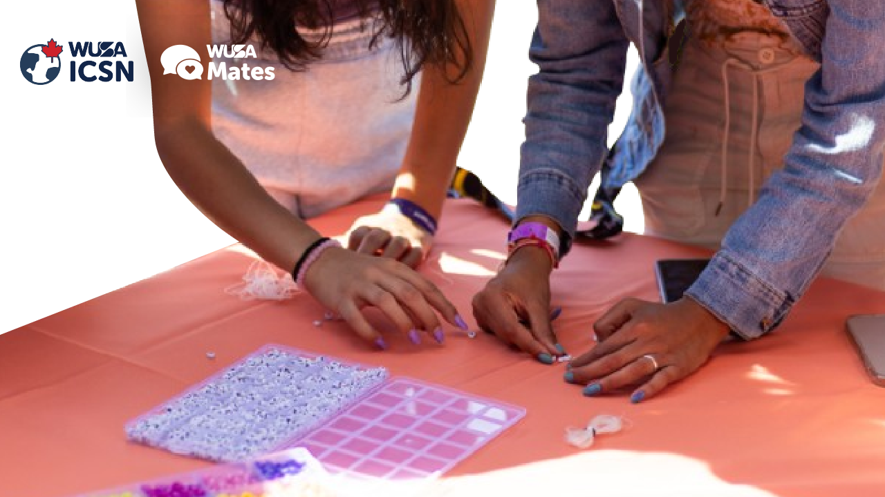 Two people enjoy bracelet making at a table, creating unique DIY bracelets. WUSA ICSN and WUSA Mates logos are in the top left corner.