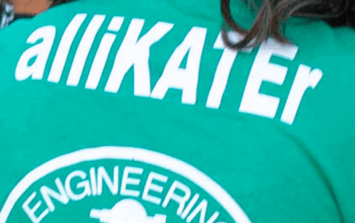 Person wearing a green Engineering Orientation Leader T-Shirt featuring bold white name customization on the back, highlighting unique personalization.
