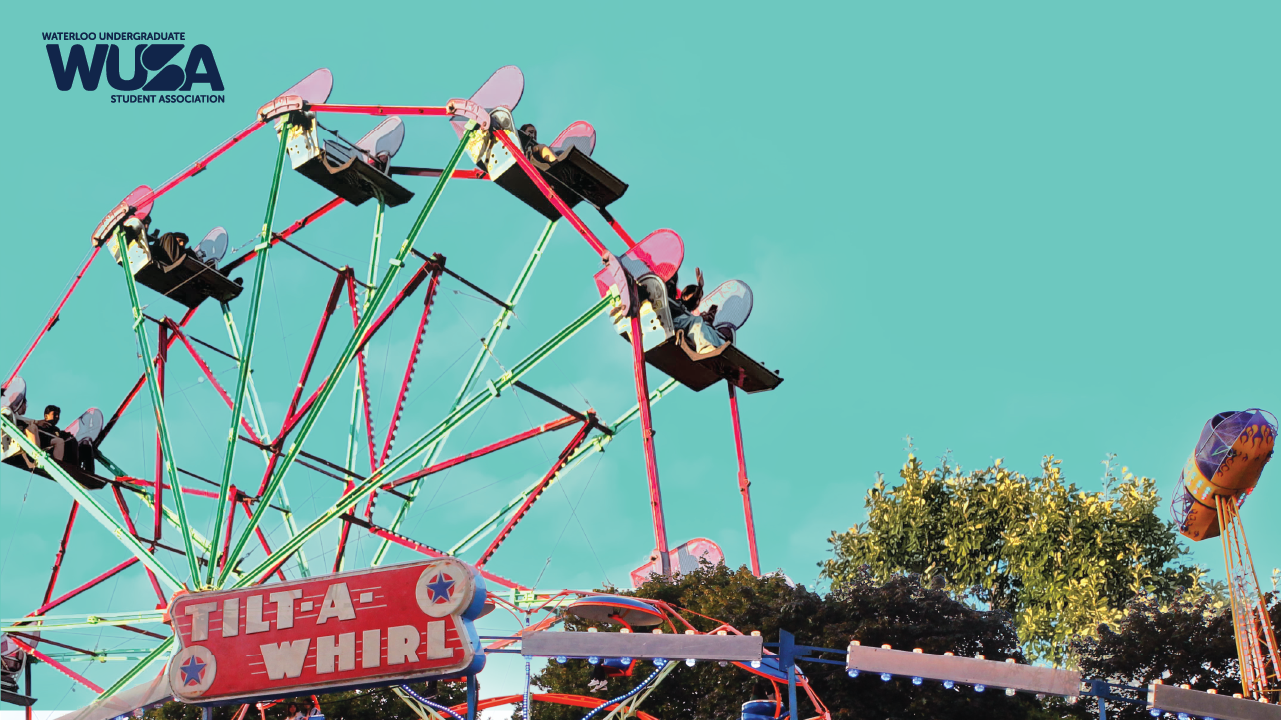 A Ferris wheel and Tilt-A-Whirl ride at the Welcome Week Carnival, with trees and a clear blue sky in the background.
