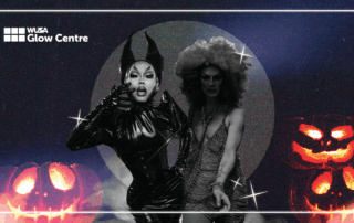 Two drag performers in Halloween costumes light up Fruity Fright Night, surrounded by glowing jack-o’-lanterns and a full moon—an event perfect for all ages.
