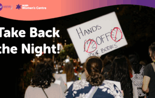 A group of people at night hold signs, including one reading "Hands off our bodies," during a Take Back the Night event to raise awareness and support survivors.