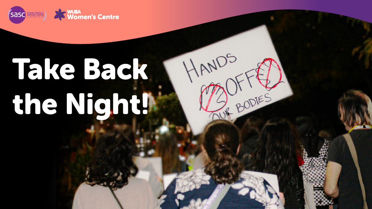A group of people at night hold signs, including one reading "Hands off our bodies," during a Take Back the Night event to raise awareness and support survivors.