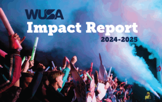 A crowd of people at a concert with light sticks, signs, and smoke with the title WUSA Impact Report 2024-25.