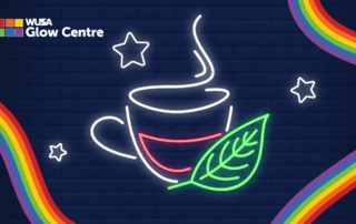 Neon tea cup with steam, a green leaf symbolizing health and wellness, stars, and rainbow borders on a dark brick background. Perfect for celebrating Wellness Wednesdays.