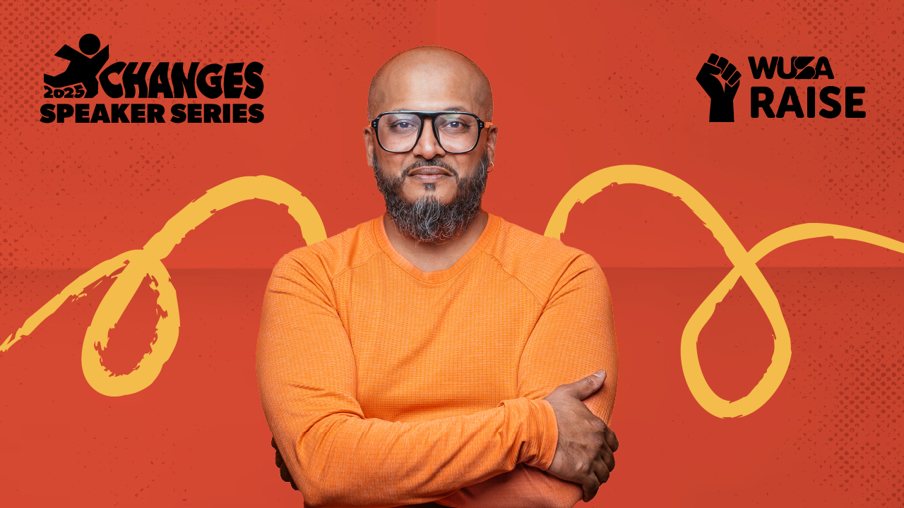 A man in orange stands with folded arms in front of “XChanges Speaker Series” and “WUSA Raise” logos on red, highlighting the theme of Mentorship Through Play.