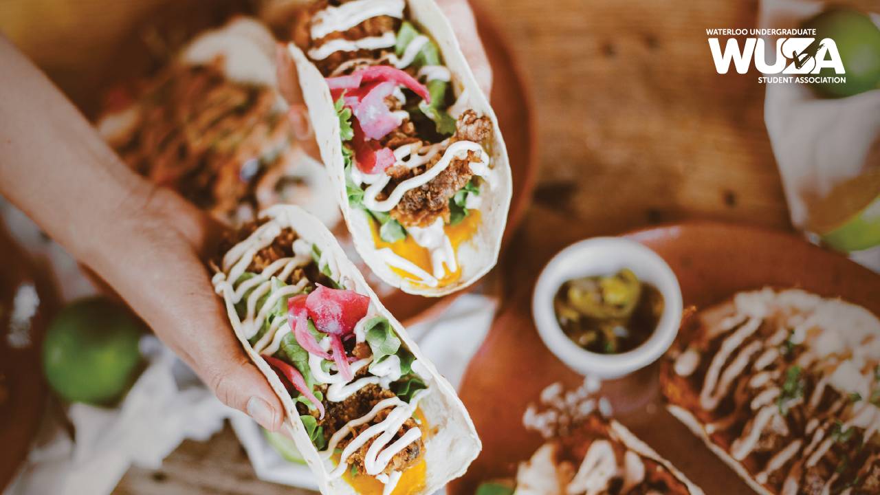 A person holding a taco with sauces, ready to Taco ’Bout the best flavors.
