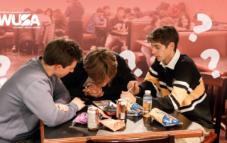 Three students sit at a table with snacks, discussing and thinking during Trivia Night, with question marks around them.