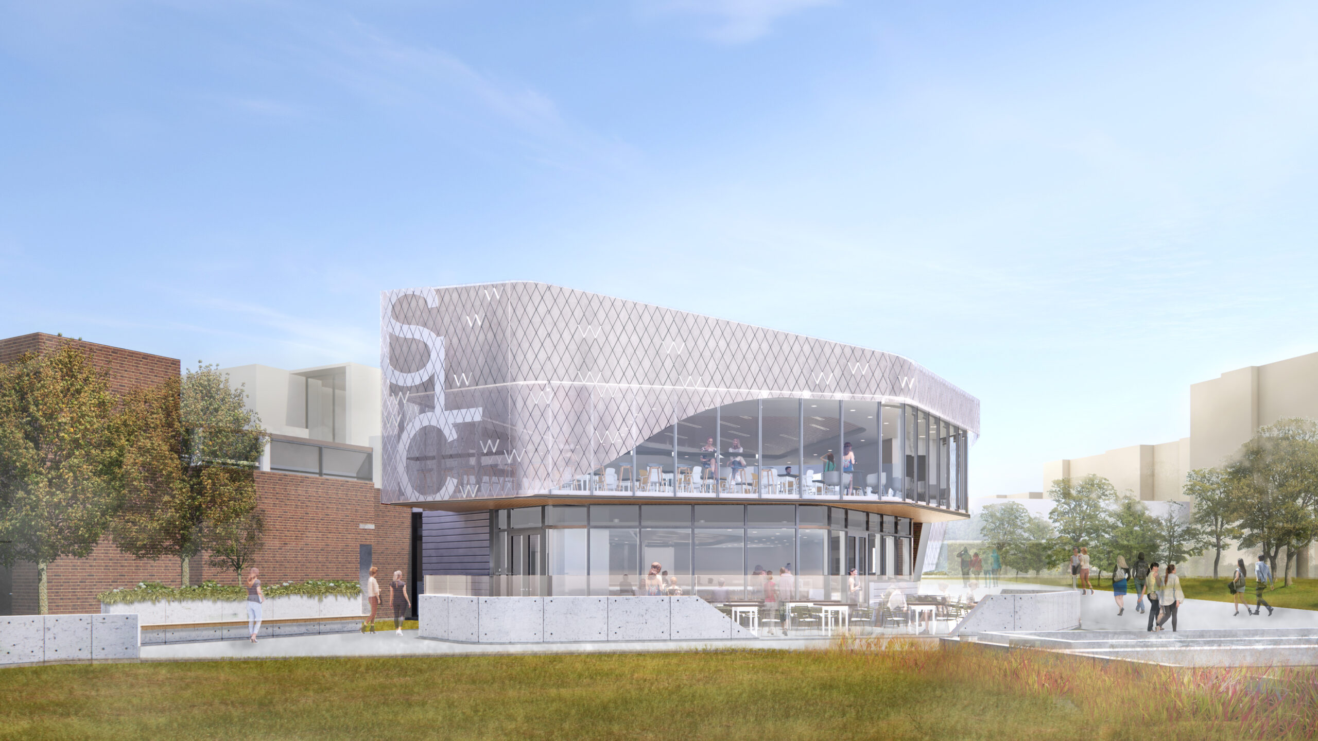 Modern two-story building with large windows and outdoor seating, surrounded by grass and people walking nearby.