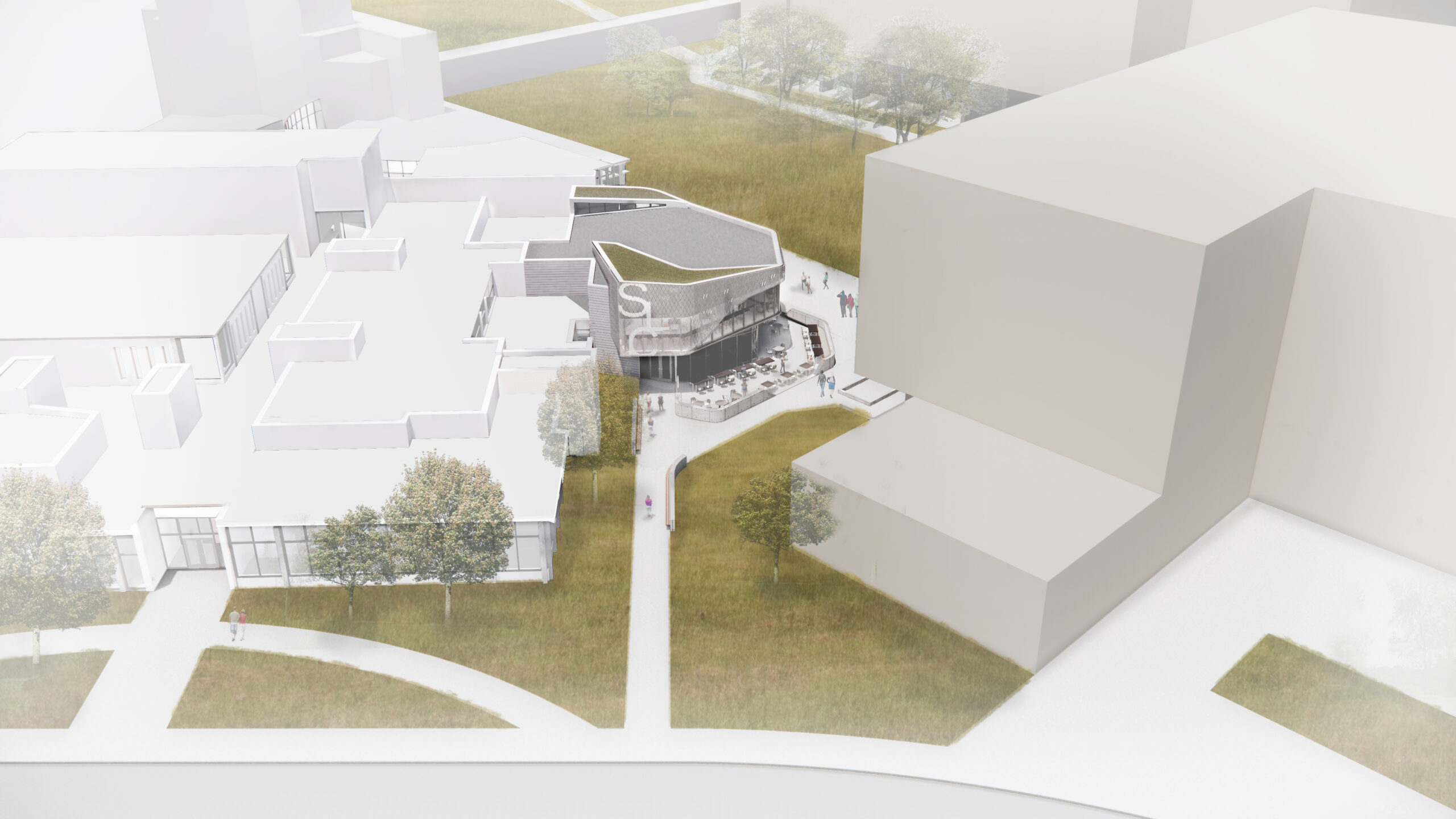 Aerial view of a modern building with glass facade, surrounded by paths, grass, and trees.