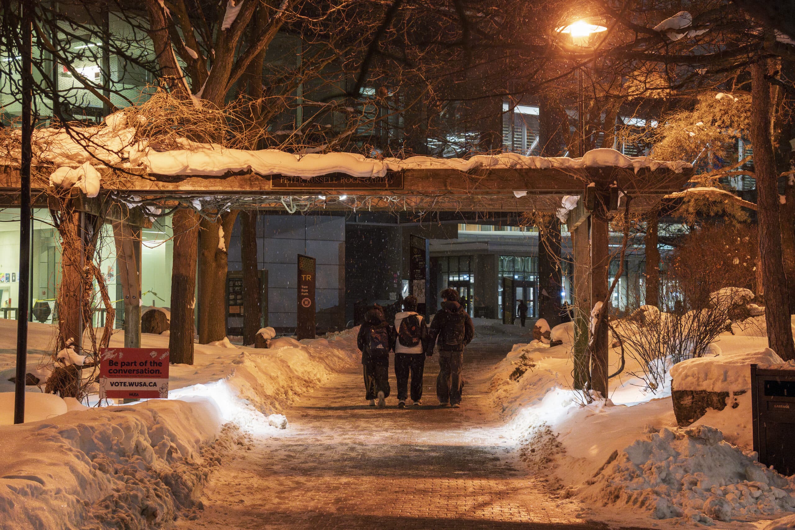 Students walking in the dark on UW Campus.