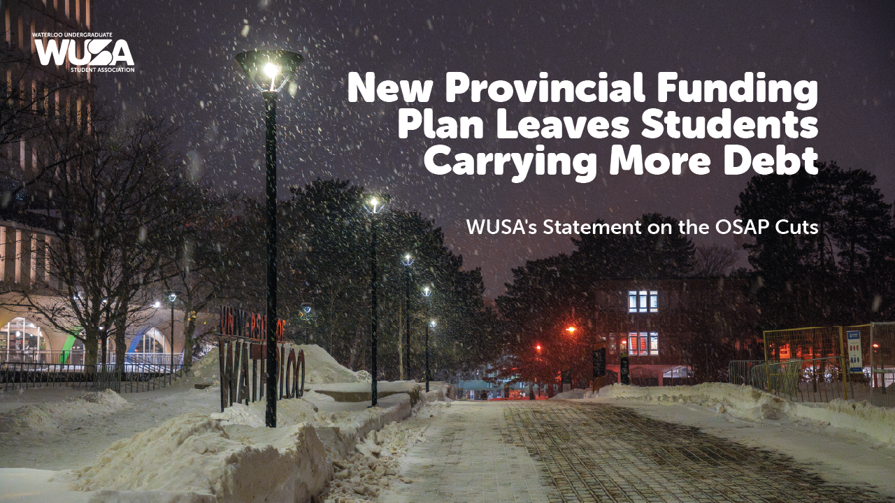 Snowy campus pathway at night with streetlights.