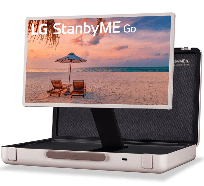 Portable LG StanbyME Go display from the AV Catalogue in an open suitcase, showing a beach scene with chairs and an umbrella.