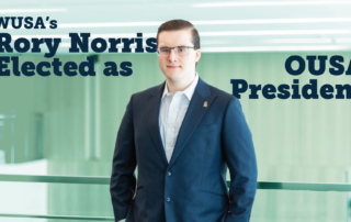 A man in a suit stands confidently; text reads "Rory Norris Elected as OUSA President," highlighting his significant achievement in student leadership within WUSA.