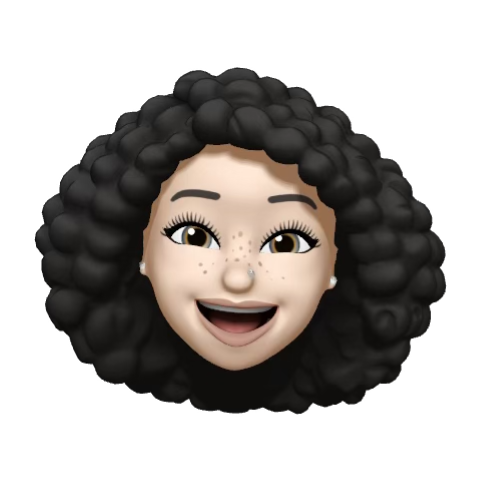 Majdalen Smiling cartoon-style face with curly black hair, freckles, light skin, and wide expressive eyes.