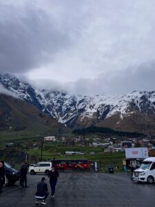 Snow-capped mountains tower above a small town.