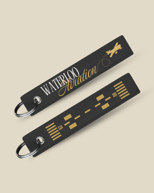 Show off your UW spirit with the UW Aviation Society - Runway Flight Tags! This set features two black fabric keychains—one displaying "Waterloo Aviation" with a plane, and the other with gold runway markings—making them perfect unique accessories for any Aviation Society enthusiast.