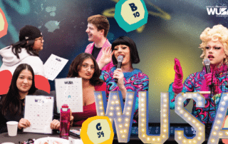 Drag queens host Sex Toy Bingo as students play and hold cards; colorful bingo balls and WUSA logo are visible.