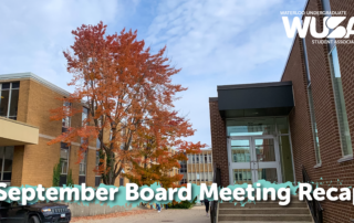 September Board Meeting recap text overlaying an autumn tree and university building.
