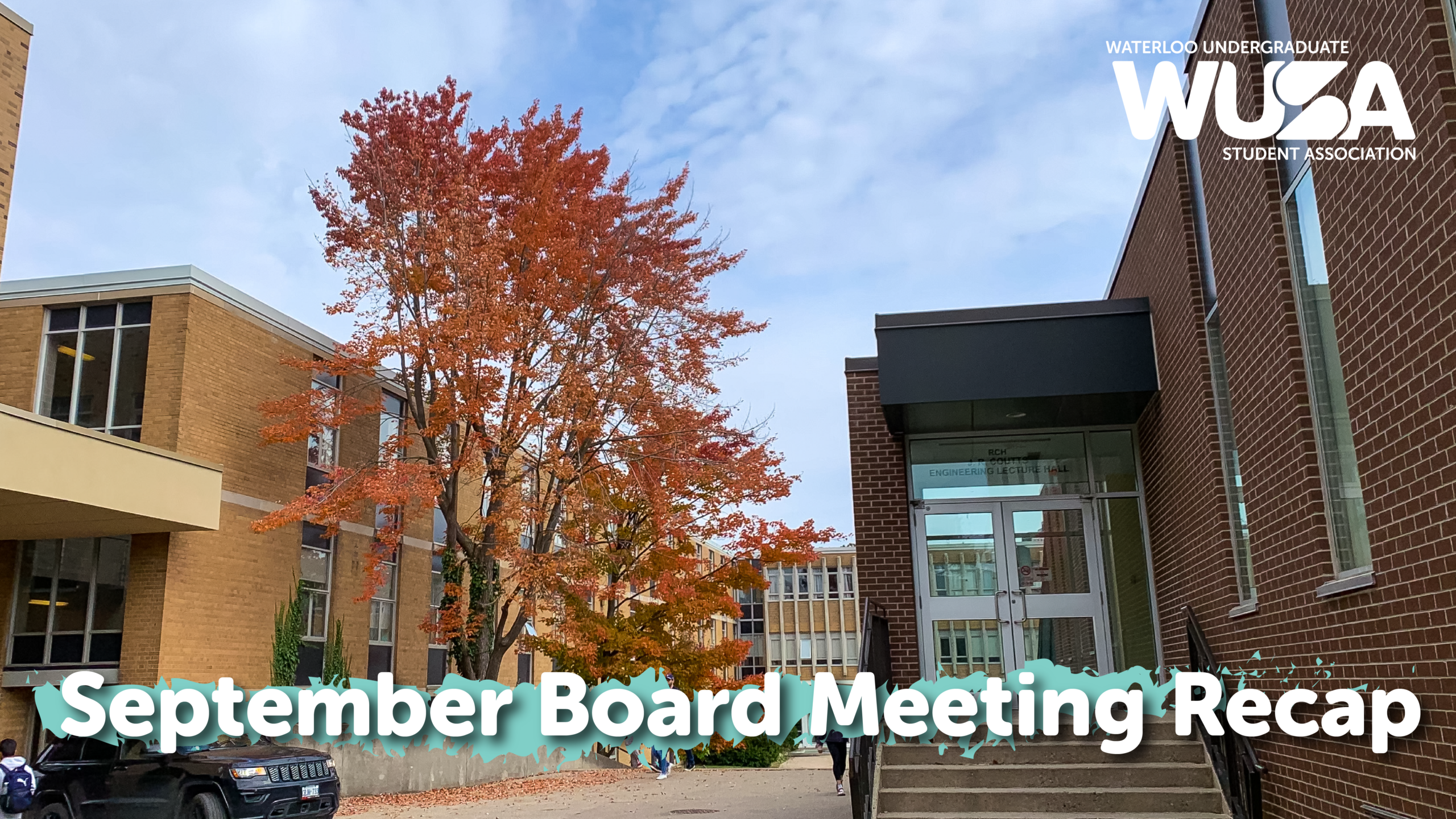 September Board Meeting recap text overlaying an autumn tree and university building.